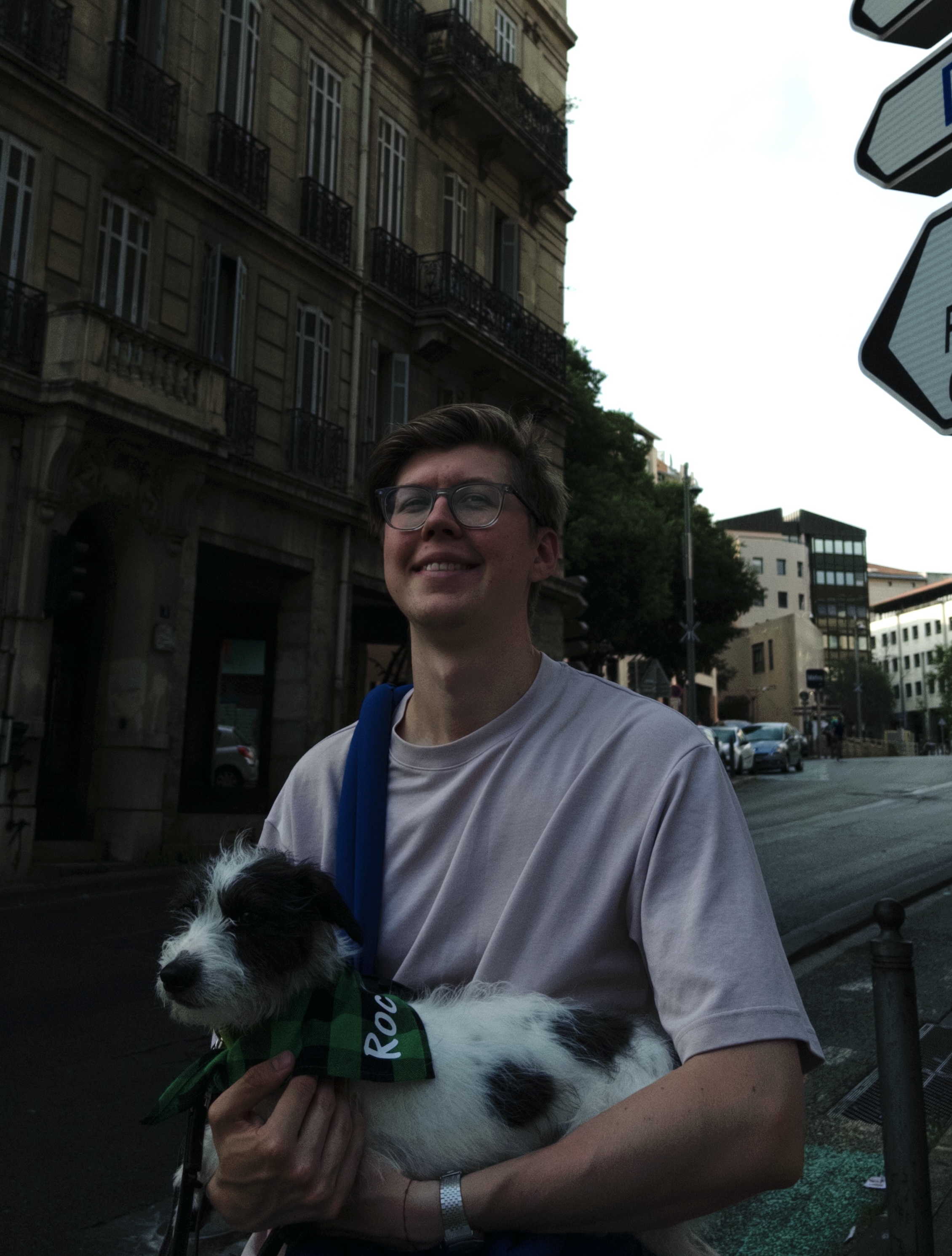 Alexander Moshchev holding a dog on a city street